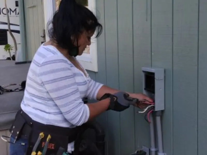 Licensed electrician wiring an exterior subpanel in Tomah